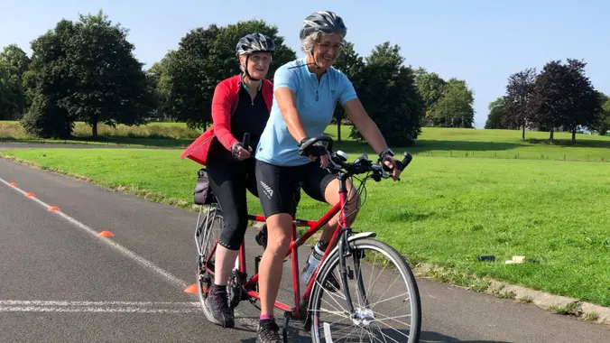 Diane and Anne riding a tandem on the outdoor velodrome in Bellahouston park