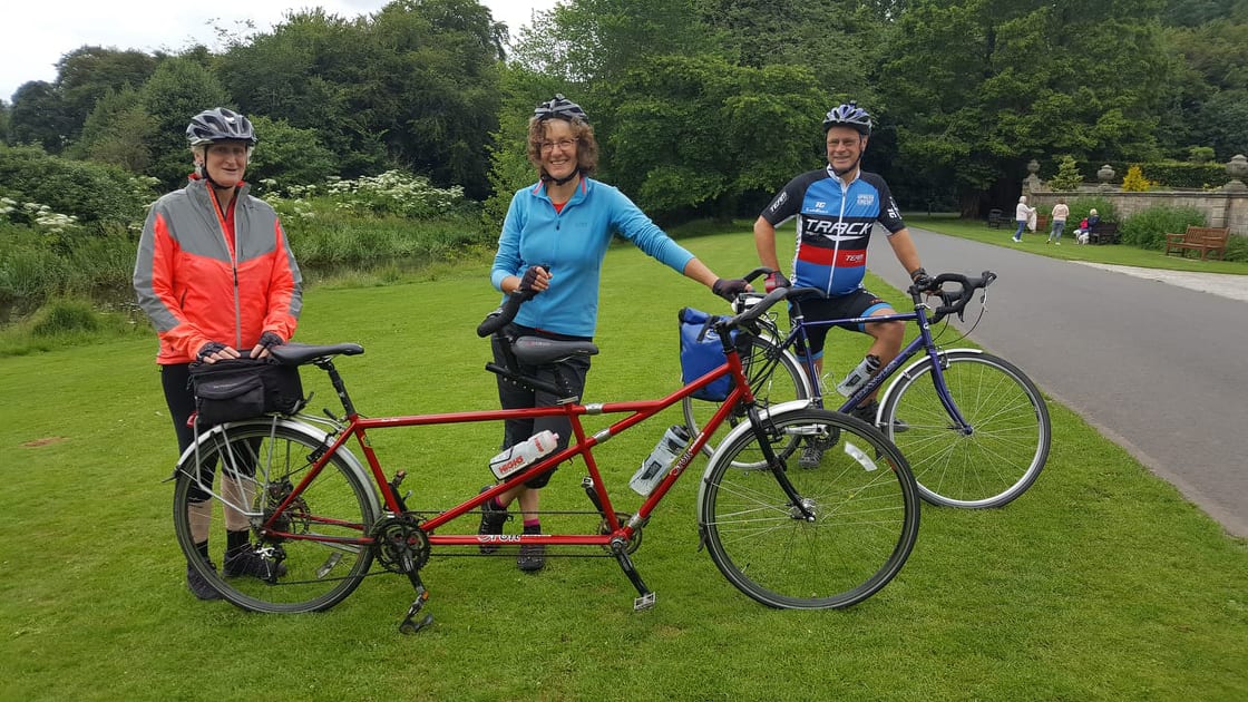 Anne, Diane and Martin posing with their tandem and bicycle.