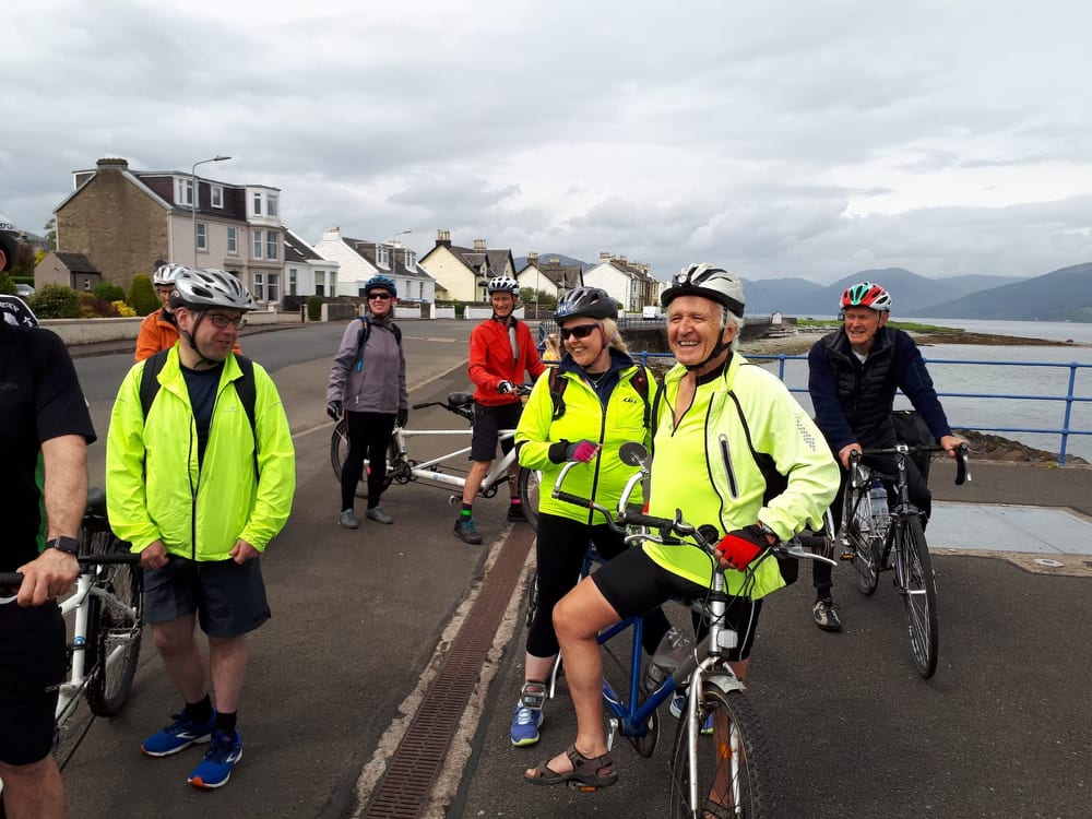 A group of eight riders taking a rest break on the Isle of Bute