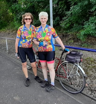 Glasgow Tandem Club's founder Anne Fraser, pictured with pilot Diane and her tandem at a railway platform.