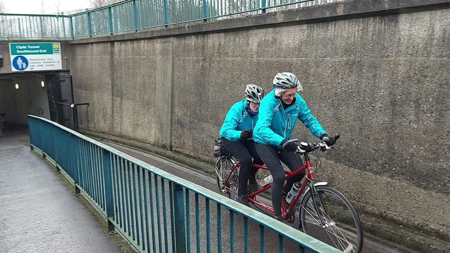 Diane and Anne in matching blue jackets puffing their way to the end of the tunnel